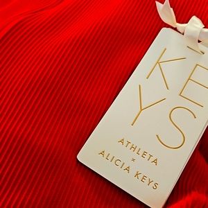 alicia keys ribbed red jumpsuit with gold detailing